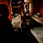 Hilario Lopez Peres, left, and Honorio Hilario sit in their home in Arcadia after retuning from a days work in the tomato field. The home sleeps 23 illegal immigrants who work in the field for $42 a day.